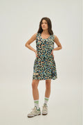 Woman wearing a patterned dress on a plain background