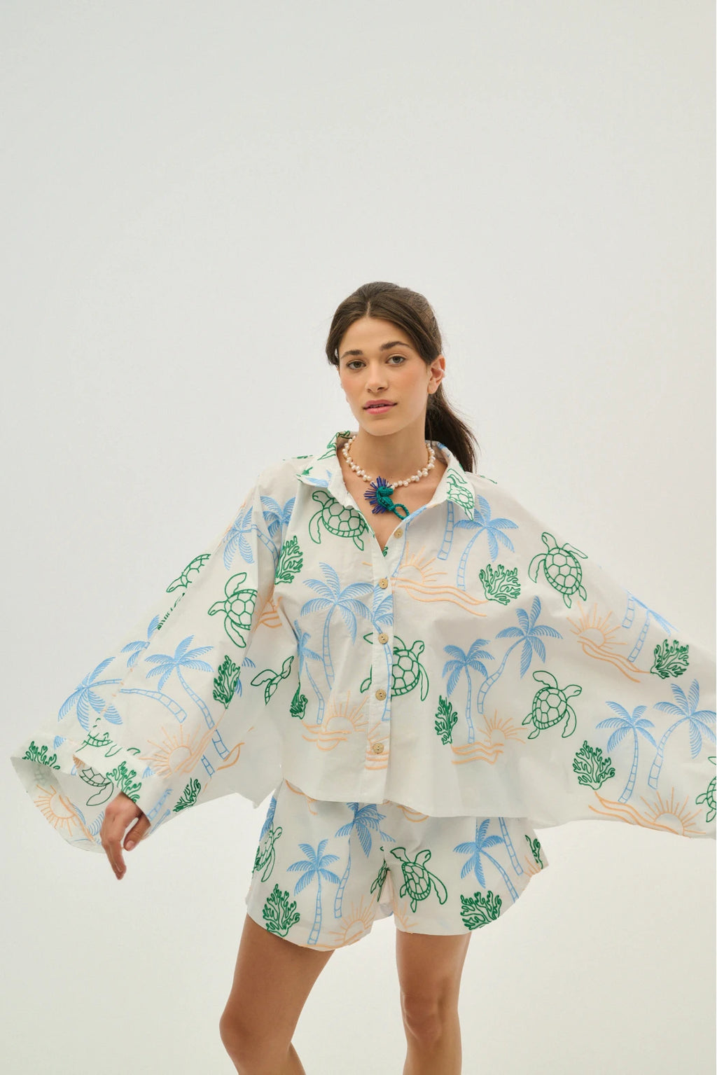Woman wearing a tropical-themed outfit with a white background