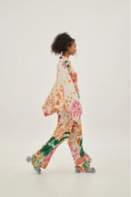 Woman wearing a colorful floral outfit on a white background
