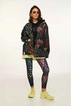 Person wearing a patterned jacket, leggings, and shoes on a white background
