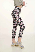 Person wearing patterned leggings on a plain background