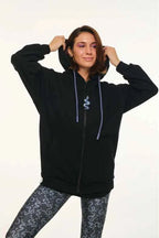 Person wearing a black hoodie with a snake design on a white background