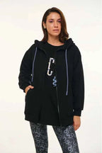 Person wearing a black hoodie with a carabiner on a white background