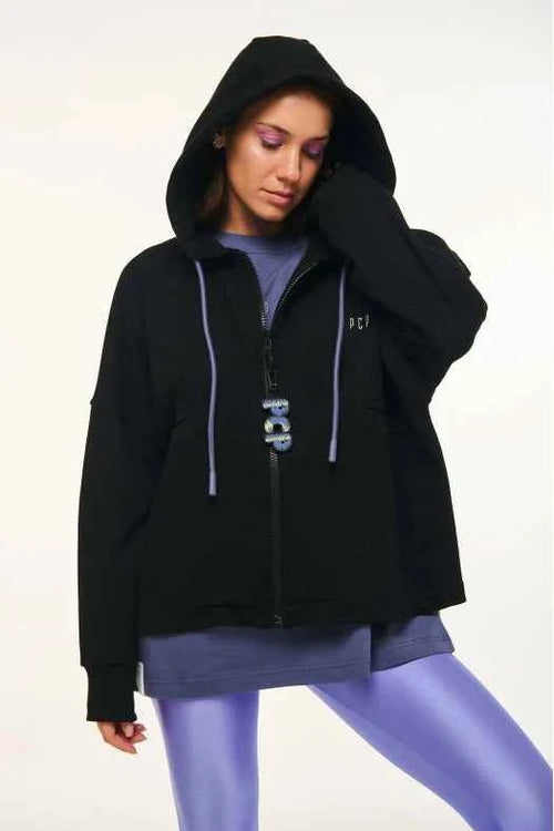 Person wearing a black hoodie with a logo on a white background