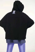 Black hooded jacket with a visible brand label on a white background