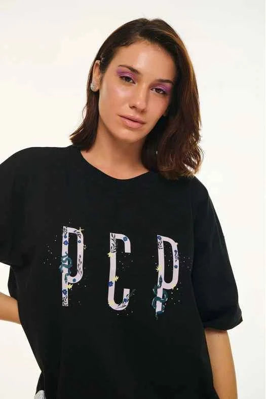 Person wearing a black t-shirt with 'PCD' design on a white background