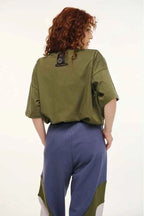 Person wearing a green and blue outfit with a white background