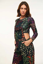 Woman wearing a colorful patterned outfit on a white background