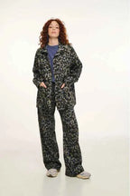Person wearing a patterned outfit on a white background