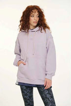 Person wearing a light purple hoodie on a white background
