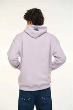 Person wearing a light purple hoodie with a white background