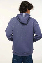 Person wearing a purple hoodie with star patterns on the back against a white background