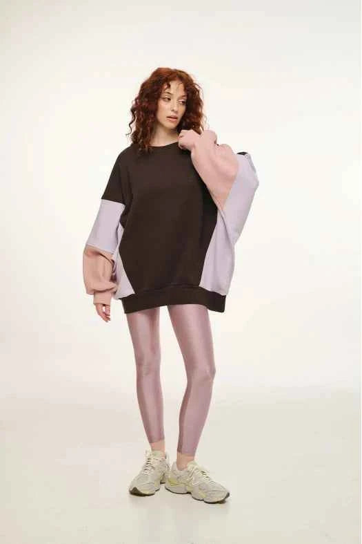 Person wearing a black and white color-blocked outfit on a plain background