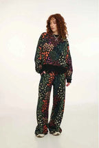 Person wearing a colorful patterned outfit on a white background