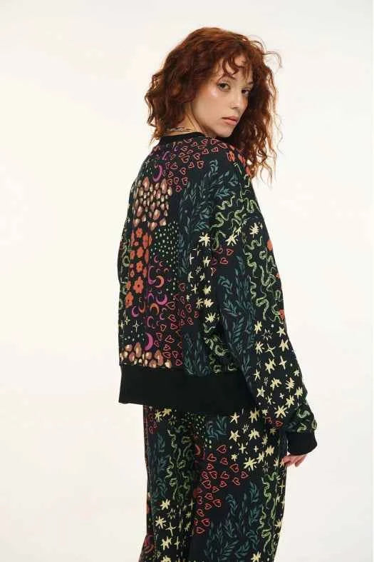 Person wearing a colorful patterned outfit on a white background