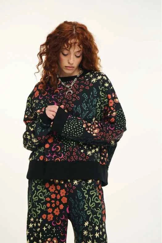 Person wearing a black patterned outfit on a white background