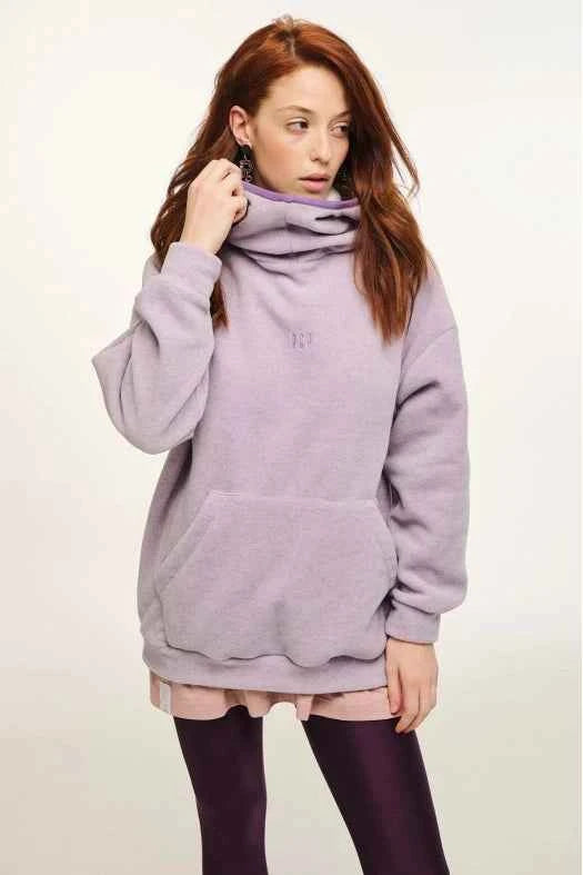 Person wearing a light purple hoodie on a plain background