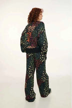 Person wearing a colorful patterned outfit on a white background