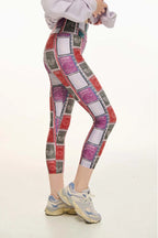 Person wearing colorful patterned leggings on a white background