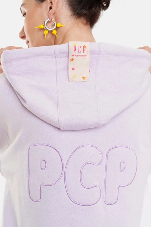 Person wearing a light purple hoodie with 'PCP' branding on the back