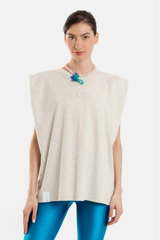 Woman wearing a grey sleeveless top with 'PCP' branding on a white background