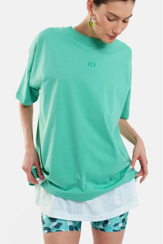 Person wearing a green athletic outfit with a logo on a white background