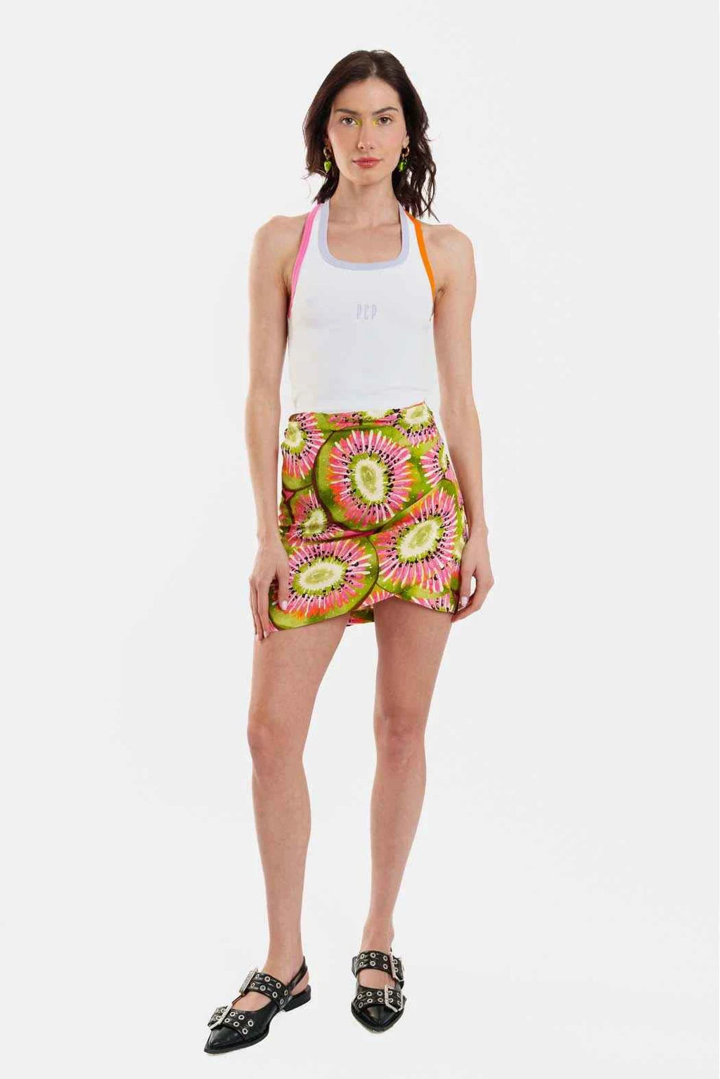 Woman wearing a colorful patterned skirt on a white background