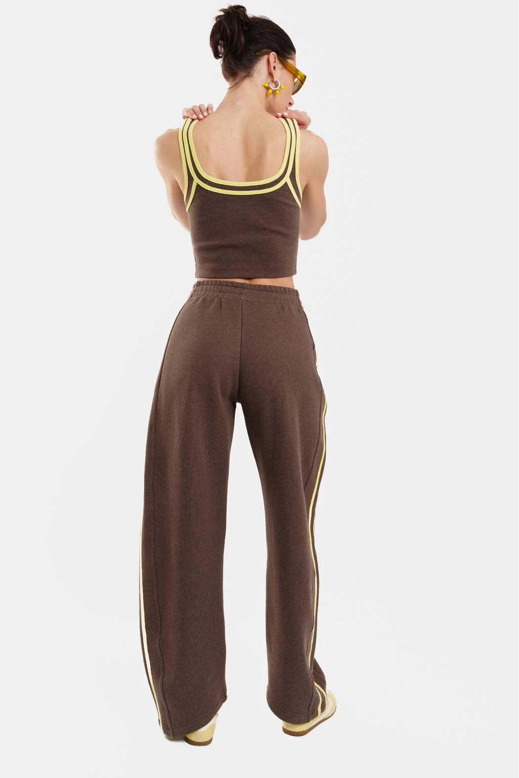 Person wearing a brown outfit with a white background