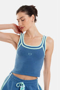 Woman wearing a blue athletic outfit with a logo on a white background