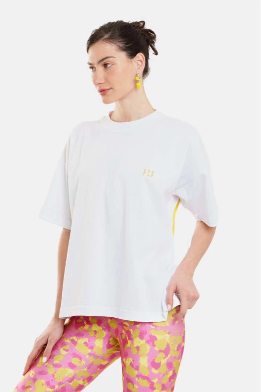 Woman wearing a white t-shirt and colorful leggings on a white background