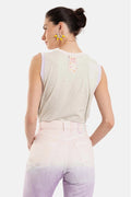 Woman wearing a sleeveless top with a visible brand logo on a white background