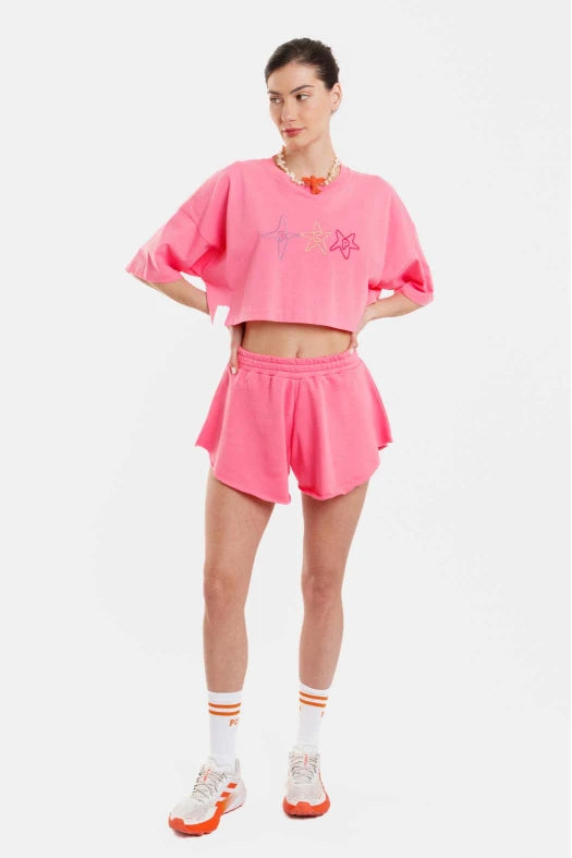 Person wearing a pink outfit with a white background