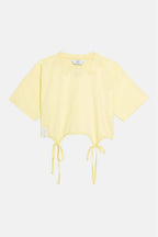 Yellow crop top with drawstring details on a white background