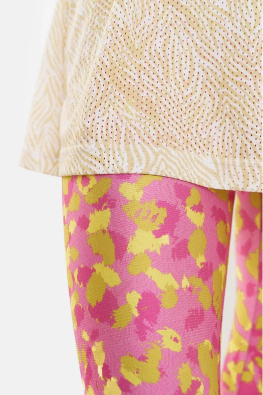 Yellow sequined top and pink floral pants on a white background