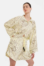 Woman wearing a floral dress with long sleeves on a white background
