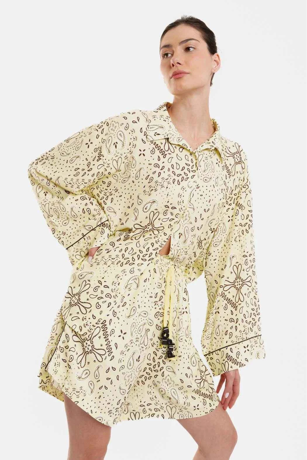 Woman wearing a floral dress with long sleeves on a white background
