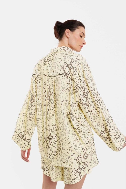 Woman wearing a floral embroidered dress on a white background