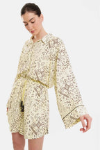 Woman wearing a yellow floral dress on a white background