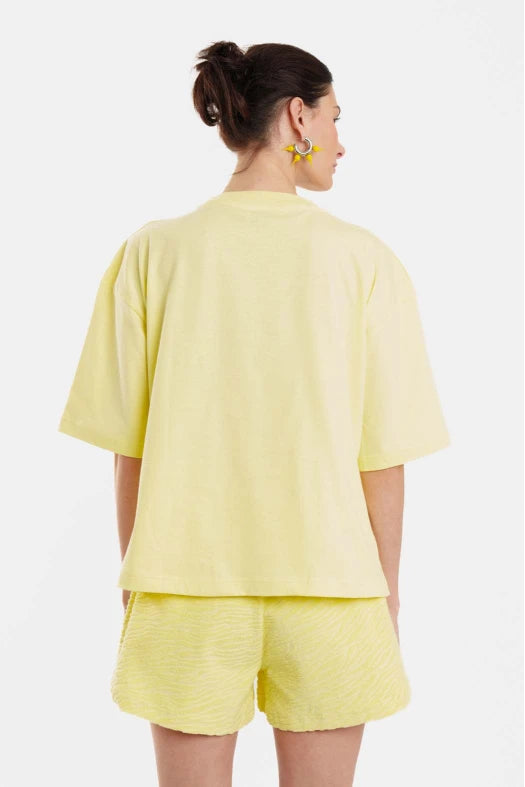 Person wearing a yellow outfit on a white background
