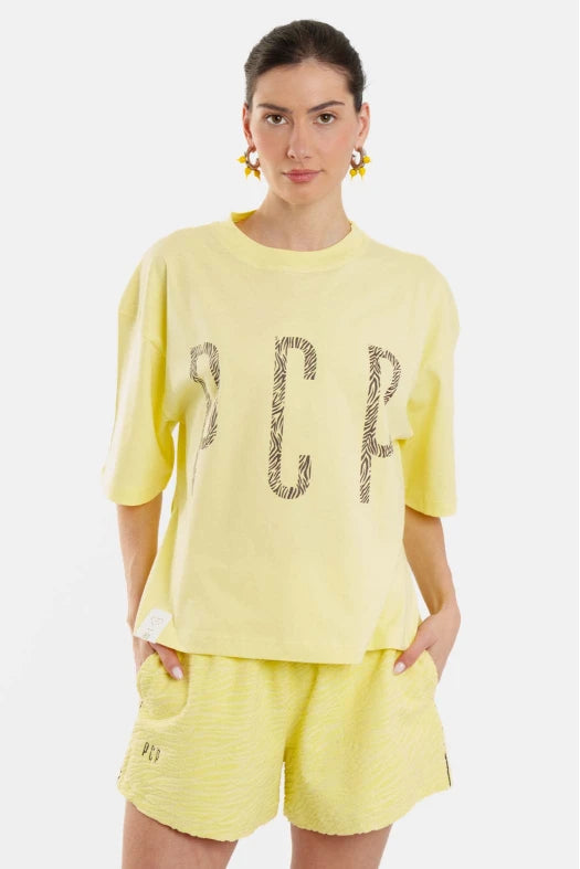 Woman wearing a yellow outfit with text design on a white background