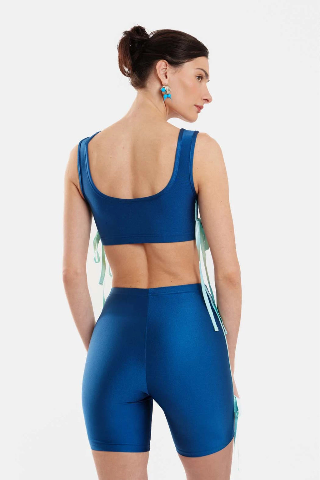 Woman wearing a blue athletic outfit on a white background