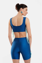 Woman wearing a blue athletic outfit on a white background