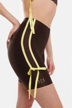 Black swimsuit with yellow straps on a white background