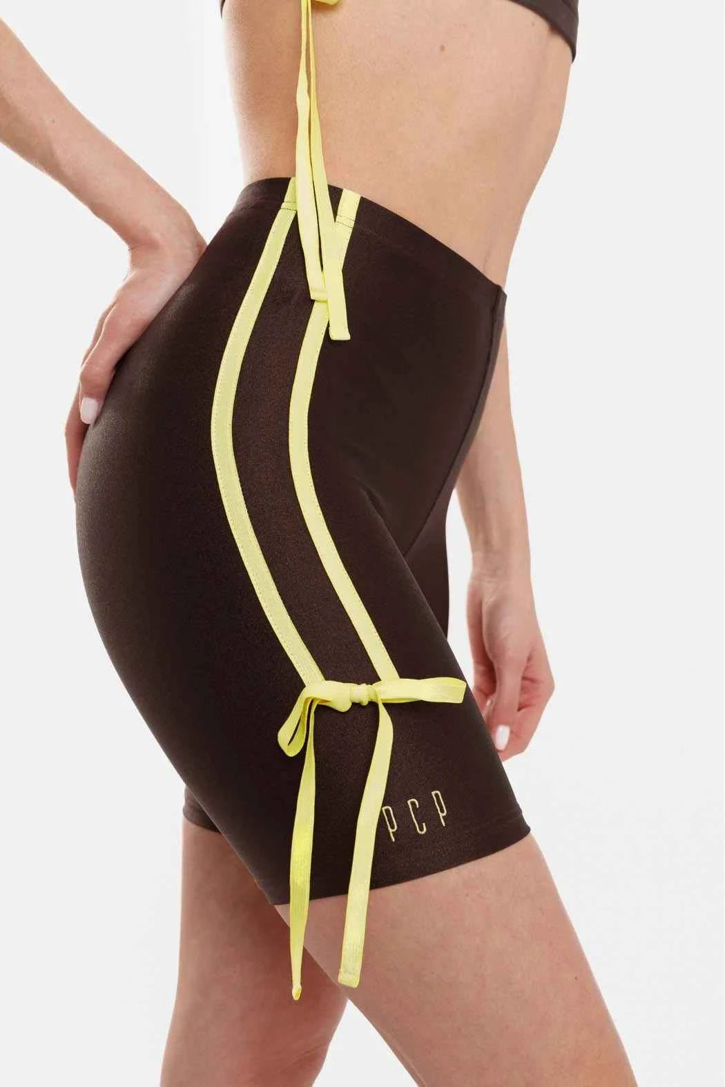 Black swimsuit with yellow straps on a white background