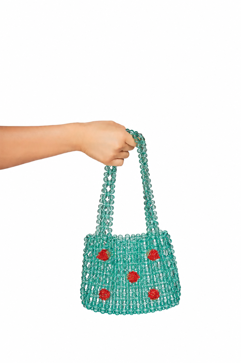 Oui Odile Silvia Deep Turquoise Bag handmade turquoise beaded mini tote with red floral bead motifs held by hand