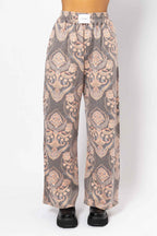 Patterned pants on a mannequin against a white background