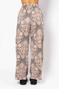 Patterned pants on a mannequin against a white background