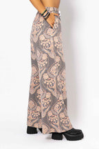 Long patterned skirt worn by a person on a white background
