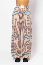 Patterned pants on a mannequin against a white background