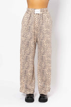 Leopard print pants worn by a person on a white background